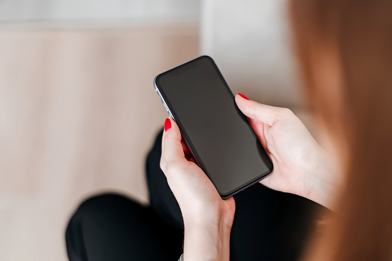 woman-holding-and-looking-at-phone-with-blank-copy (1).jpg
