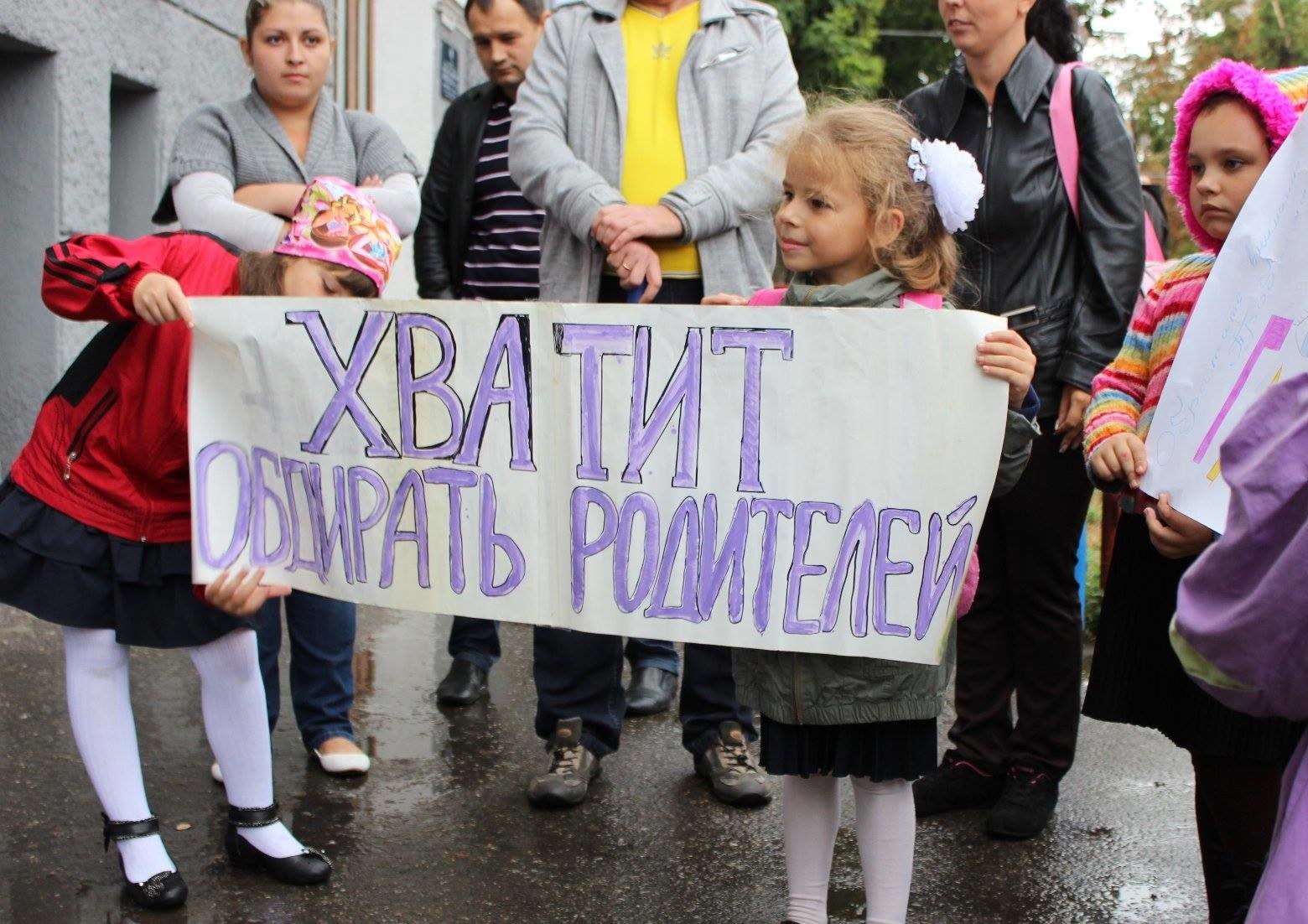 Девочка с плакатом против сборов денег в школе