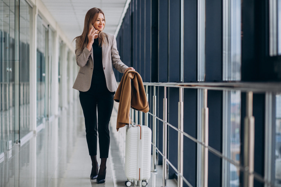 business-woman-terminal-with-travel-bag-talking-phone.jpg